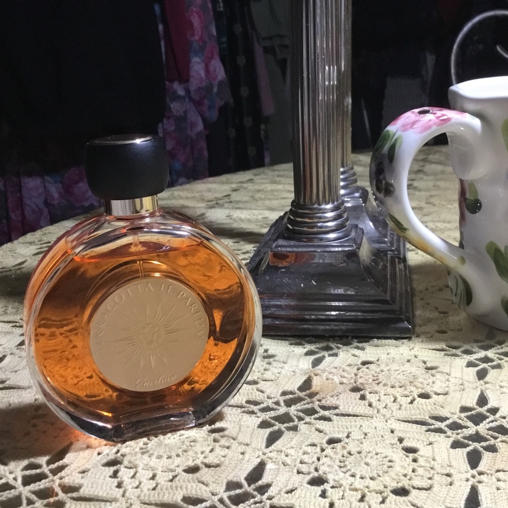 GUERLAIN Amber Glass Bottle with Silver Sun Medallion